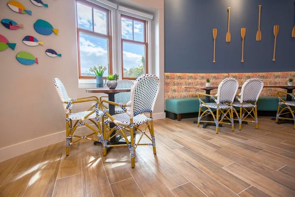 Bright common area with decorative seating and wall art