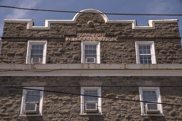 Exterior view of a historic building with text signage