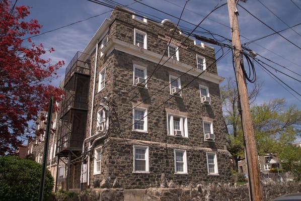 Exterior view of a stone building with utility poles
