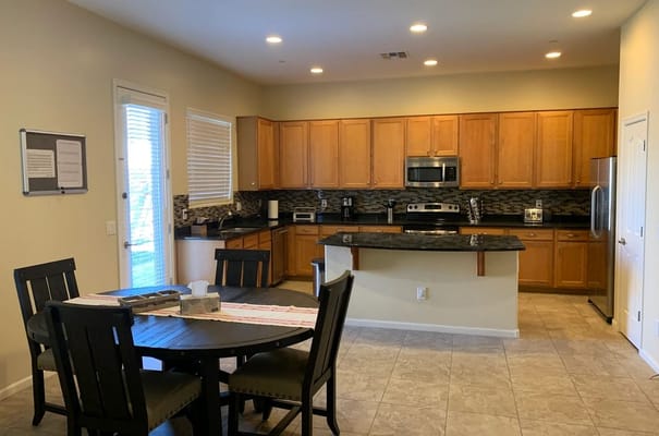 Modern kitchen area with dining table and appliances