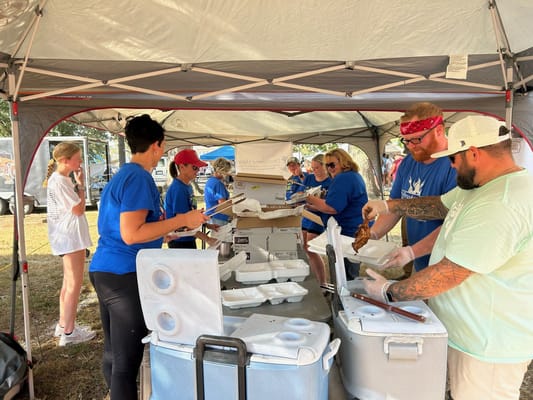 Volunteers serving food at an outdoor event
