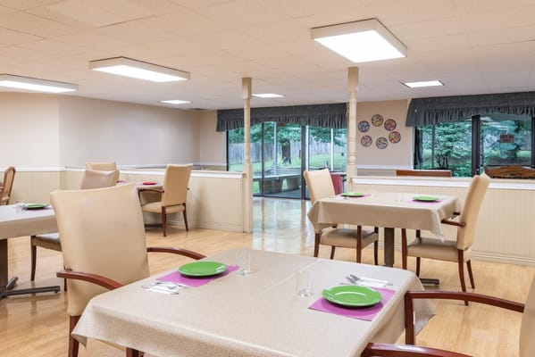 Bright dining room with tables set for meals