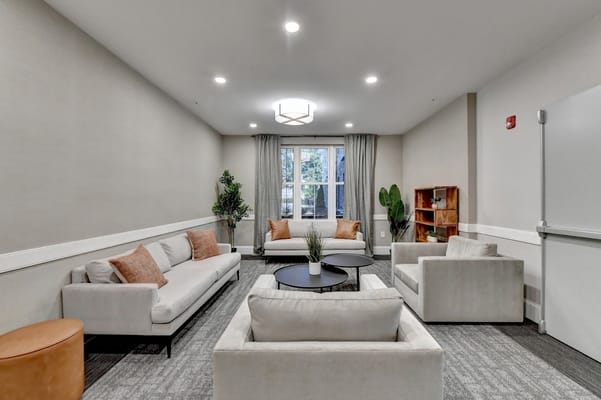 Bright common area with seating and natural light