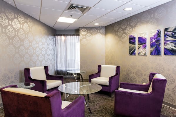 Interior lounge area with purple chairs and modern decor