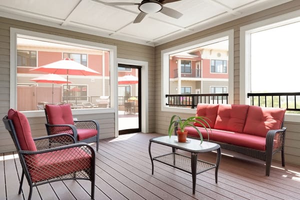 Sunlit common area with outdoor seating and umbrellas