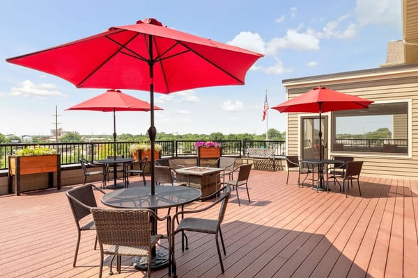 Outdoor seating area with red umbrellas and views
