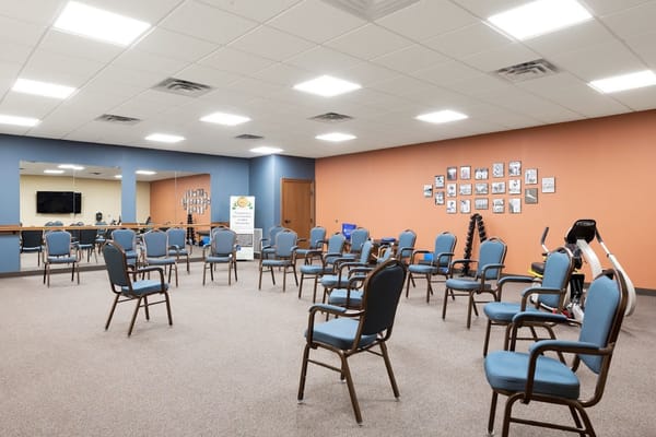 A common area with chairs arranged in a meeting room