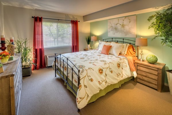 Cozy bedroom in a senior living facility with floral bedding