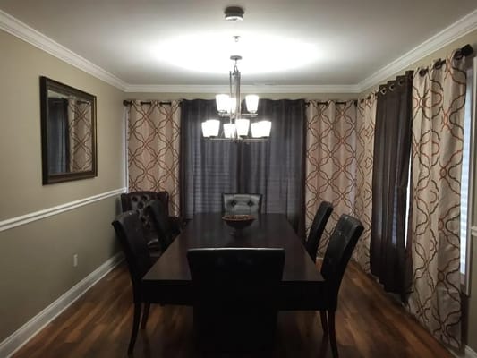 Elegant dining room with a long table and black chairs