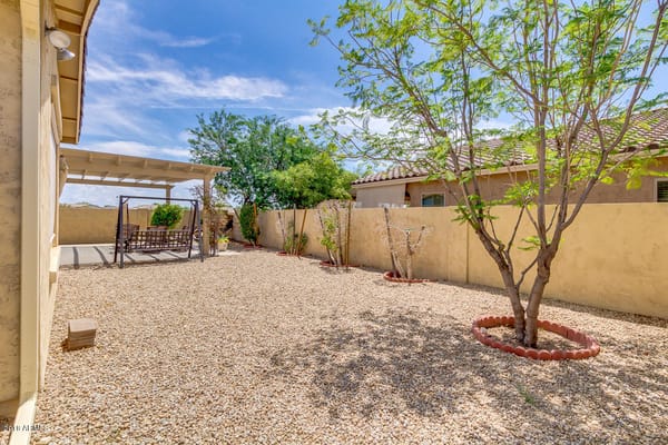 Outdoor backyard space with seating area and landscaping
