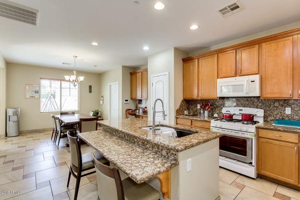 Modern kitchen with granite countertops and dining area