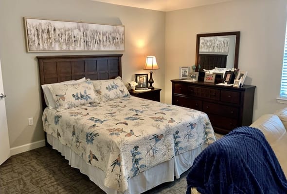 Cozy bedroom with a floral comforter and personal touches