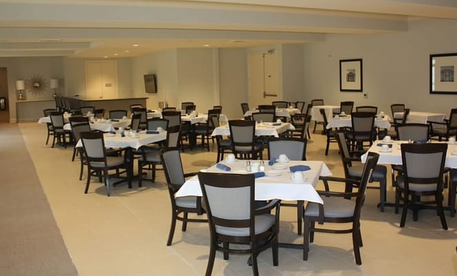 Spacious dining room with tables set for meals