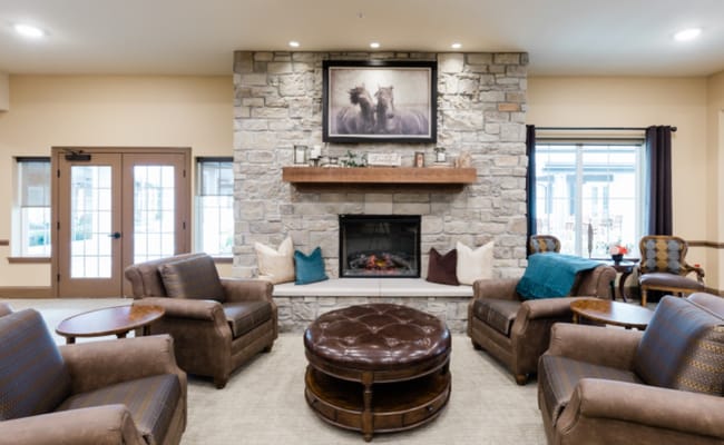 Cozy lounge area with stone fireplace and seating