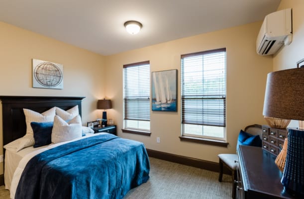 Cozy resident room with bed, decor, and windows