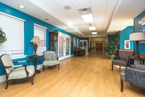 Brightly colored hallway with seating areas in the Gallatin Center