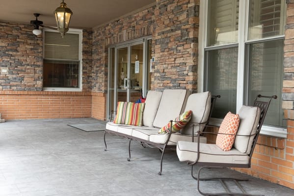 Seating area on the porch with colorful cushions