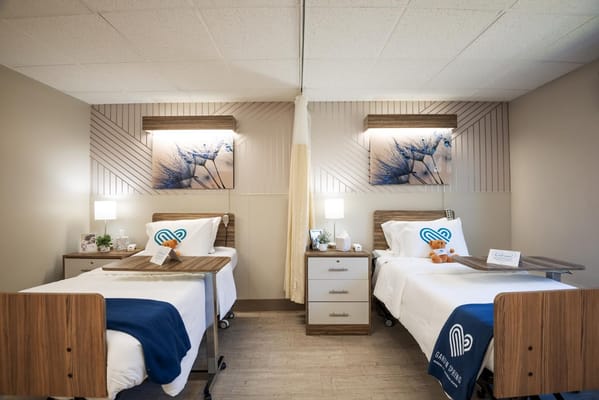 Well-decorated shared resident room with beds and personal items