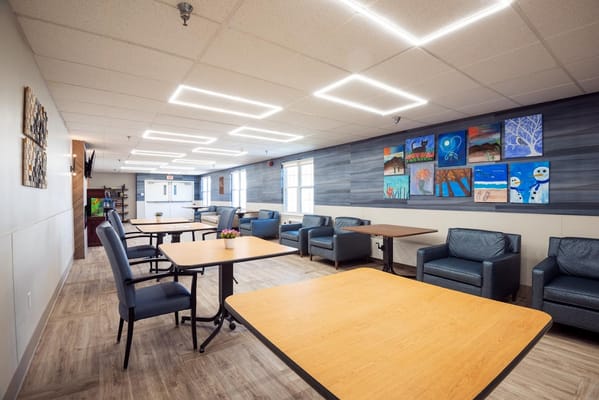 A bright common area with seating and artwork