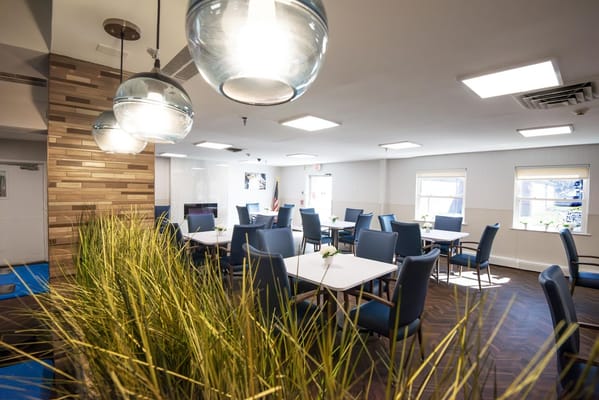 Bright dining room with blue chairs and tables