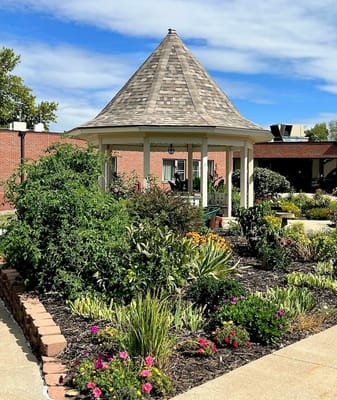 Beautiful outdoor gazebo surrounded by blooming flowers