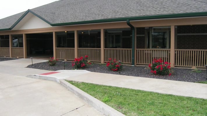 Front view of the facility with flowers and walkway