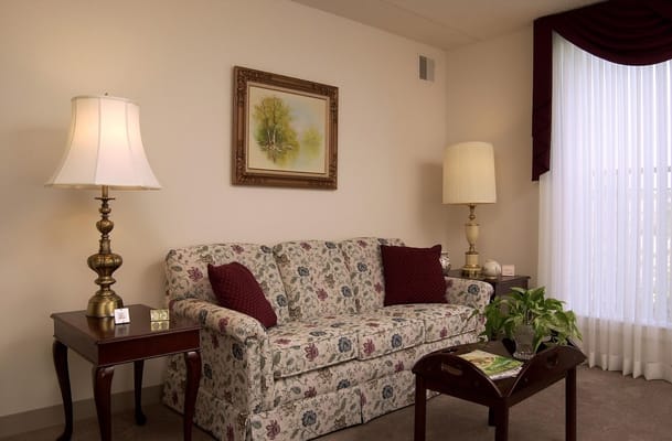 Cozy living room area with floral couch and lamps