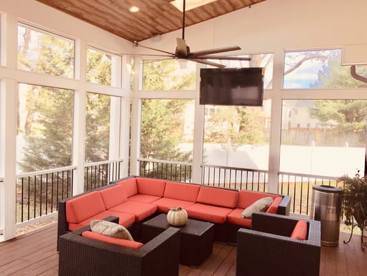 Cozy sunroom with a red sectional and coffee table