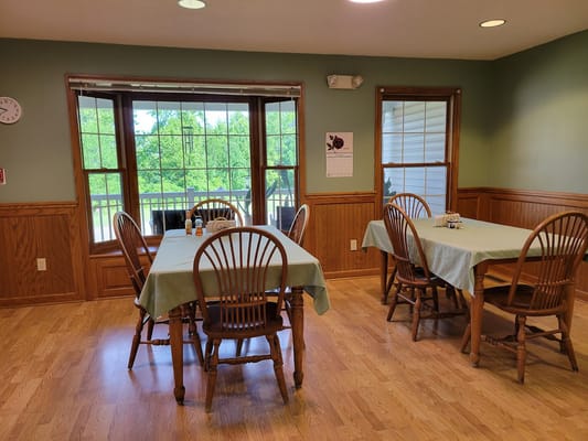 Dining room with tables and chairs in a warm setting