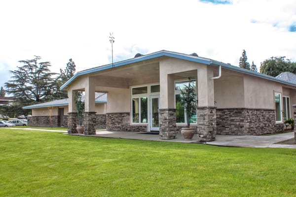 Exterior view of Heritage Gardens showcasing landscaped area and entrance