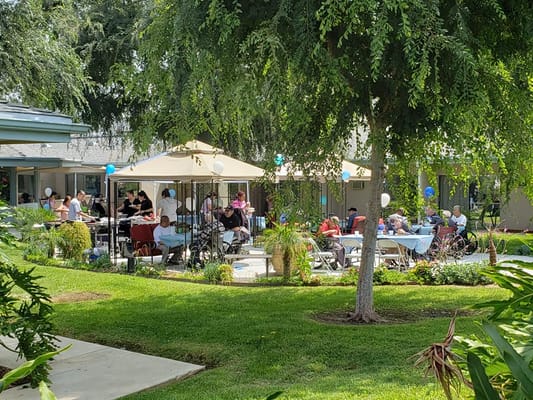 Residents enjoying an outdoor event under canopies