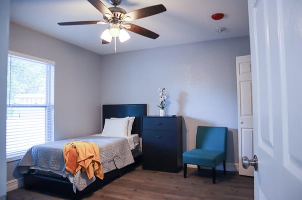 Cozy private resident room with bed and chair