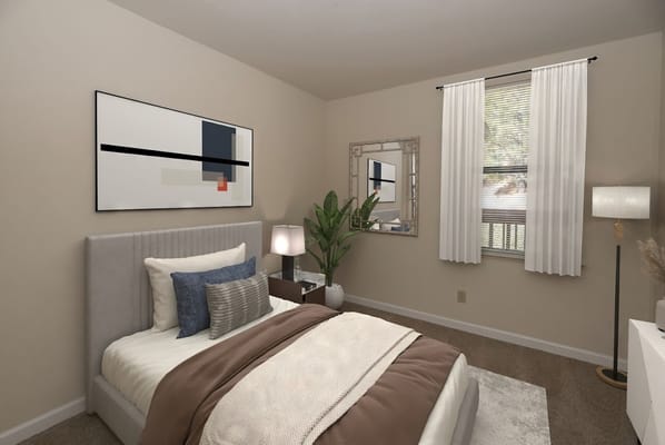 Stylish bedroom with a bed, decorative pillows, and a plant.