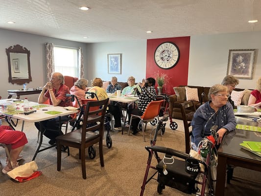Senior residents participating in an activity in a common room.