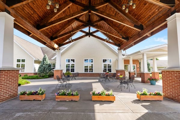 Covered outdoor patio with seating and flower boxes