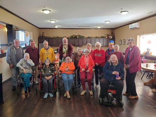 Group of residents and staff posing together in a common area.