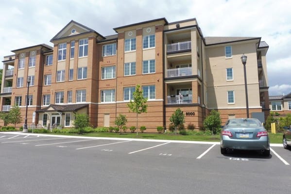 Exterior view of Kirkland Village building with parking lot