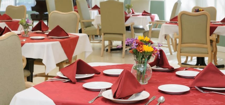 Dining room set with flowers and red tablecloths