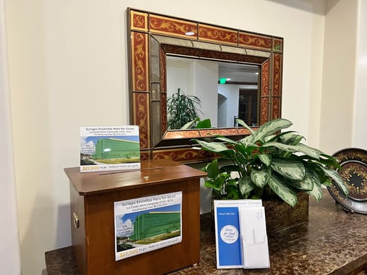 Wooden donation box with flyers in lobby