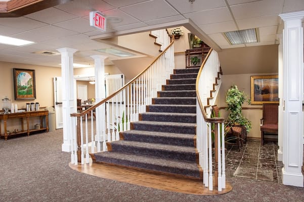 Welcoming staircase in a senior living facility lobby