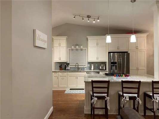 Modern kitchen with white cabinets and a view of the dining area