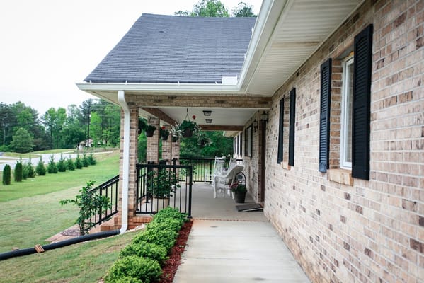 Covered porch with rocking chairs and planters