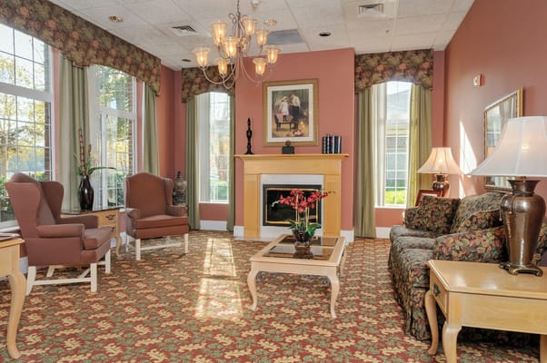 Cozy lounge area with seating and a fireplace