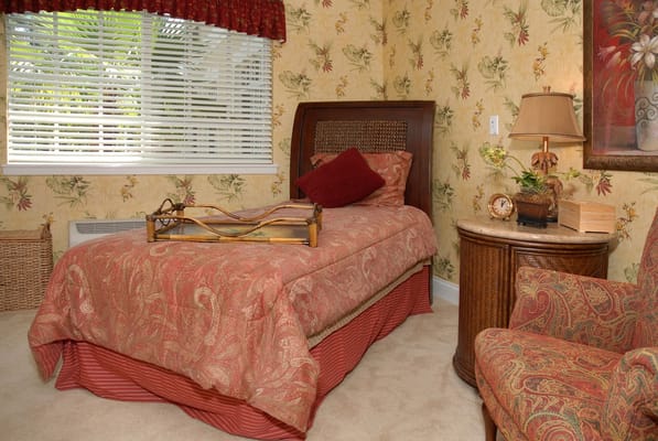 Cozy private resident room with floral wallpaper