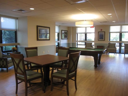 Interior view of the game room with a pool table and seating area