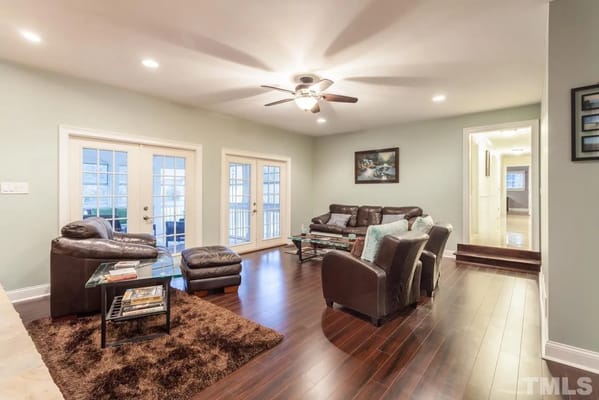 Spacious living room with leather furniture and glass coffee table