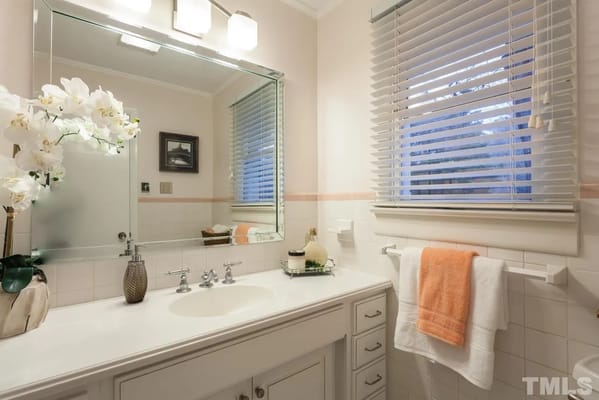 Bright bathroom with modern fixtures and decorative elements.
