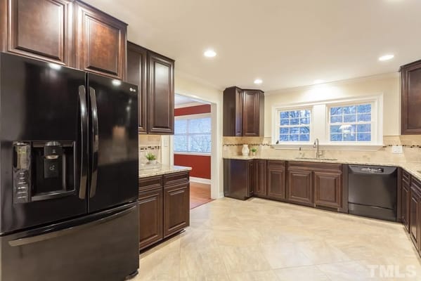 Modern kitchen with dark cabinetry and appliances