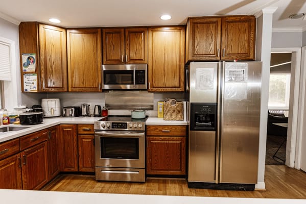 Bright kitchen with stainless steel appliances and wooden cabinets