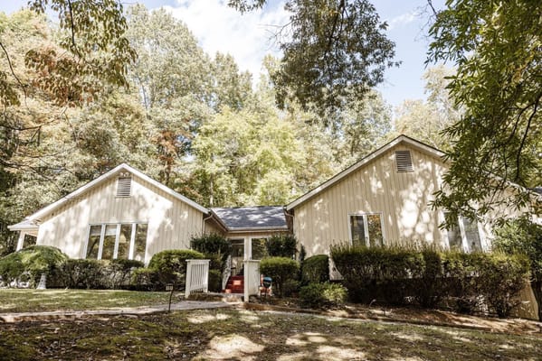 Front view of the building surrounded by greenery